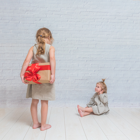 the baby, girl birthday gift, holiday, Christmas, white brick wall backgroundの写真素材