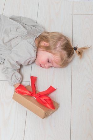 the baby, girl birthday gift, holiday, Christmas, white brick wall backgroundの写真素材