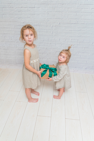 the baby, girl birthday gift, holiday, Christmas, white brick wall backgroundの写真素材