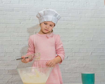 the girl cook baby cooking in the kitchen baking