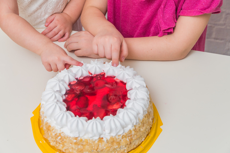 the girls, children hands eating cake close-upの写真素材