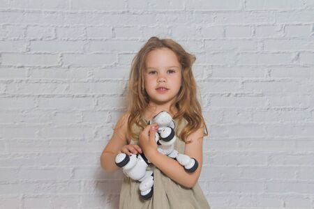 baby girl playing takes care of dog robot