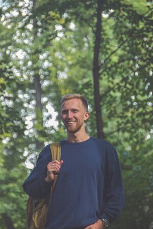 the young man with a beard in a Park among the treesの写真素材