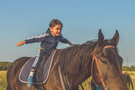 Russia Nikolskoye September 23, 2020 - boy rides a horse hippotherapy classのeditorial素材