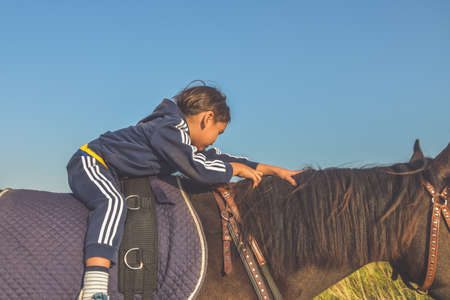 Russia Nikolskoye September 23, 2020 - boy rides a horse hippotherapy classのeditorial素材
