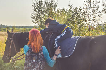 Russia Nikolskoye September 23, 2020 - boy rides a horse hippotherapy classのeditorial素材