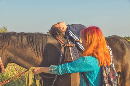 Russia Nikolskoye September 23, 2020 - boy rides a horse hippotherapy classのeditorial素材