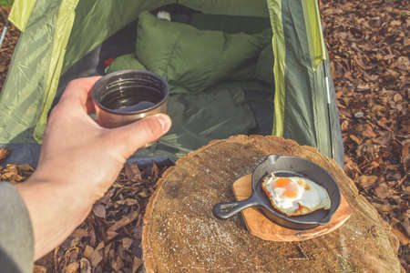 the hot tea and scrambled eggs are served for Breakfast at the campsiteの写真素材