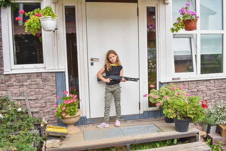 the child girl does vacuuming in the house photo without processingの写真素材
