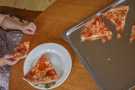 girl child cooks pizza in the oven photo without filterの写真素材