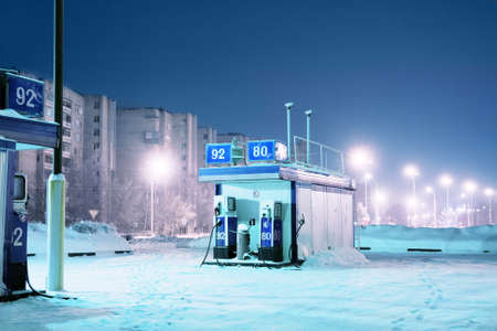 Gas station at night city lights of winterの写真素材