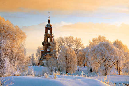 Tilt old Christian church with white trees on hill in Russiaの写真素材