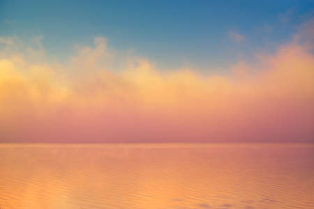 Amazing background fog cloud over river shiny wave at sunriseの写真素材