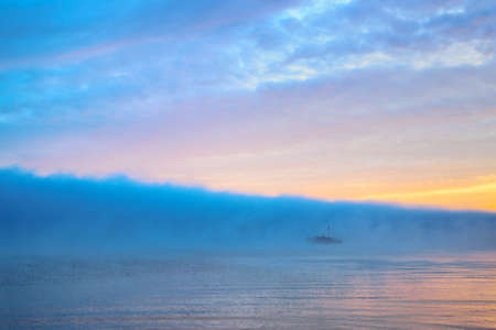 Wonderful river with large cloud of blue mist at dawn for backgroundの写真素材