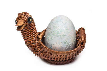 White goose Easter egg in basket for presentの写真素材