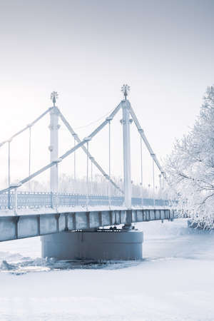 Bridge over frozen river and trees in hoarfrost. Fine artの写真素材