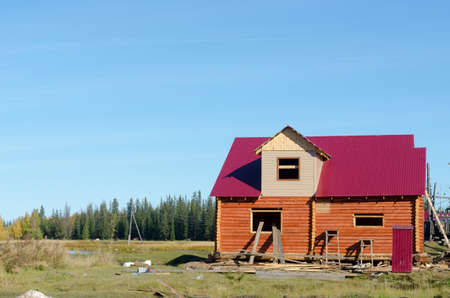 The new private cottage is being completed in the pristine area near the lake and the wild taiga of the Northern forest in Yakutia in the village of Suntar.の写真素材