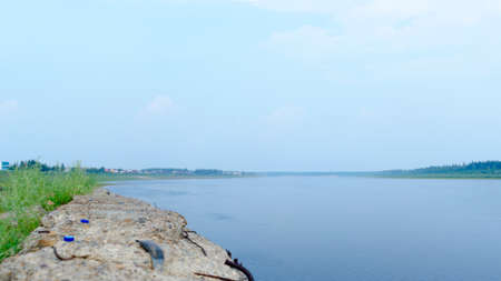 The remainder of the old pier built in the Soviet Union at the North of the Yakut river Vilyui in the background the village of ulus Suntar garbage.の写真素材