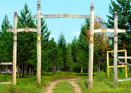 Yakut entrance to the Park in the wild far North with religious symbols of the local faith, pillars and tree of life.の写真素材