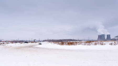 Russia, Novosibirsk - November 30, 2019. Russian low car "VAZ Zhiguli" goes quickly turning the wheel sideways in the drift on the turn in front of the pipes of the thermal power plant in winter.のeditorial素材
