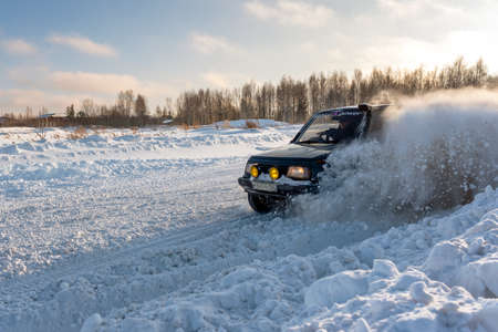 Russia, Novosibirsk-January 20, 2020 All-wheel drive 4x4 SUV "Suzuki Escudo" with fast rides raising an avalanche bumper on the road in winter in the sun.のeditorial素材