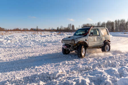 Russia, Novosibirsk-January 20, 2020 4x4 all-wheel drive SUV "Suzuki Jimny" goes quickly raising snow in winter on the road.のeditorial素材