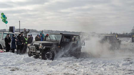 Russia, Novosibirsk-March 23, 2020. Offroad SUV "Jeep Wrangler" 4x4 with off-road training pulls the rope with the car " Range Rover"のeditorial素材