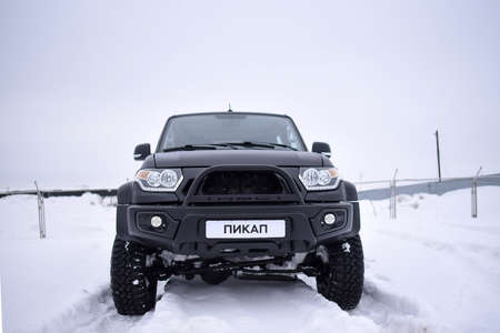 Novosibirsk, Russia -March 5, 2020. Russian black 4x4 SUV "UAZ Patriot" with the inscription "pickup" on the number is standing in the snow.のeditorial素材