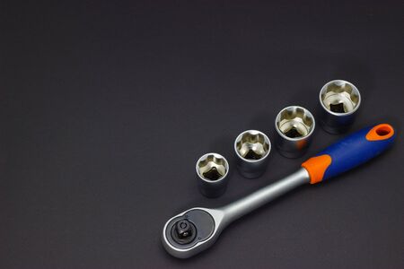 A set of tool heads for loosening screws, bolts and nuts. Ratchet screwdriver. Dark background.の写真素材