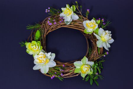 wreath decorated with daffodils on backgroundの写真素材