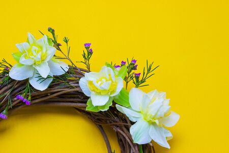 wreath decorated with daffodils on a backgroundの写真素材