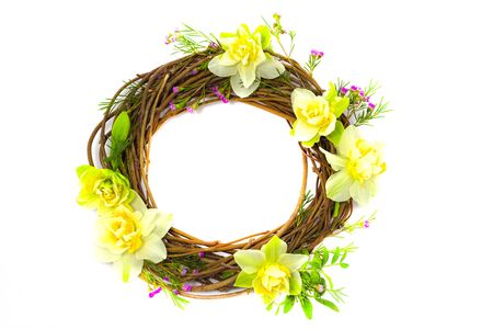 wreath decorated with daffodils on a backgroundの写真素材