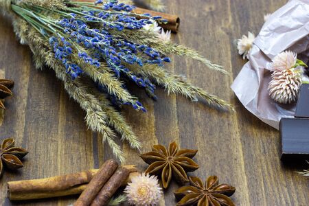 chocolate with lavender flowers cinnamon and star anise on a wooden backgroundの写真素材