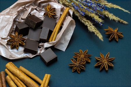 chocolate with lavender flowers cinnamon and star anise on a dark backgroundの写真素材