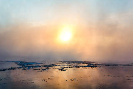 Morning fog on the river in winterの写真素材