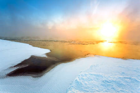 Morning fog on the river in winterの写真素材