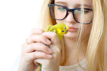 A girl with glasses and a parrotの写真素材
