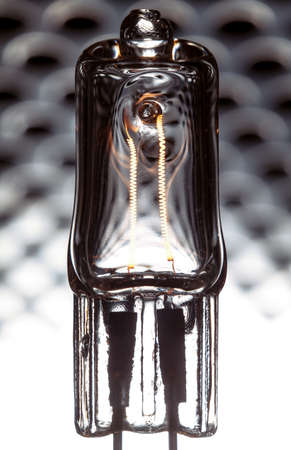Halogen lamp powered with visible incandescent filaments insideの写真素材