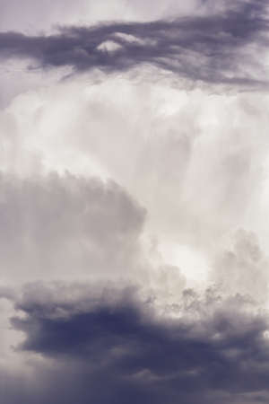 Background thunderstorm purple clouds in the blue sky