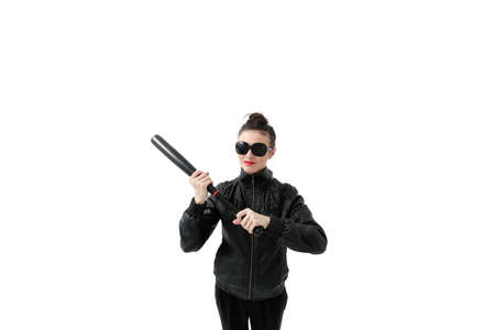 Portrait of an angry woman with a bat, isolated on white background. Serious and strict debt collectorの写真素材