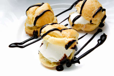 Profiteroles with ice cream with chocolateの写真素材