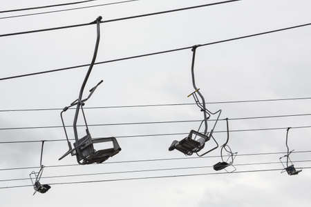 Empty chairlift with cloudy sky in the background