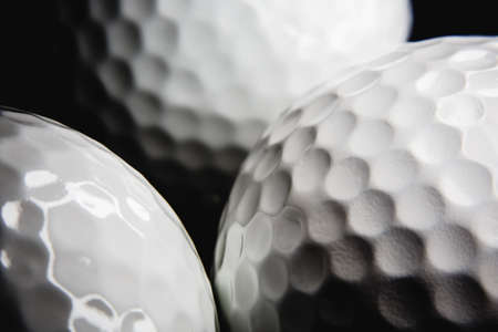 Golf ball on black backgroundの写真素材