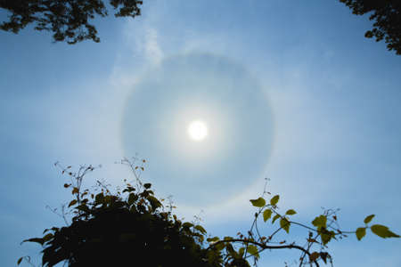 Atmospheric optical effect circle around the sun on hot summer day. Atmospheric halo phenomenon around the sunの写真素材