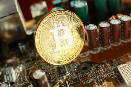 Electronic circuit blur. Bitcoin coin on electronic boardの写真素材