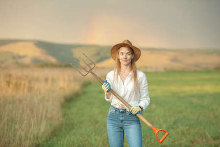 Country woman in field with pitchfork. Harvest festivalの写真素材
