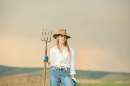 Country woman in field with pitchfork. Harvest festivalの写真素材