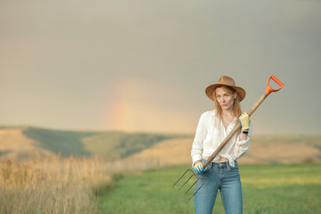 Country woman in field with pitchfork. Harvest festivalの写真素材
