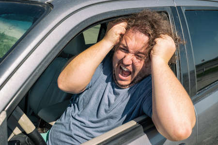 Angry fat man in the car. Road and stressの写真素材