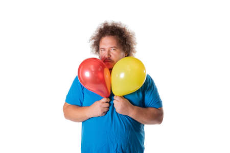 Funny fat man with balloons. Happy birthday. Joy and fun